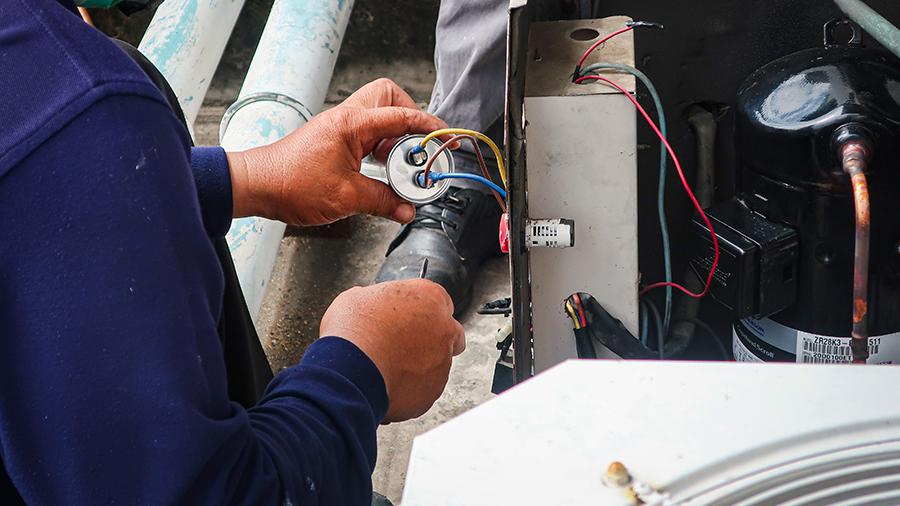 Maintenance Man Repairing Air Conditioning