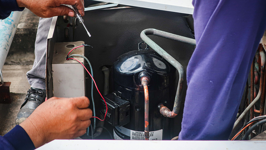 Maintenance Man Repairing Air Conditioning